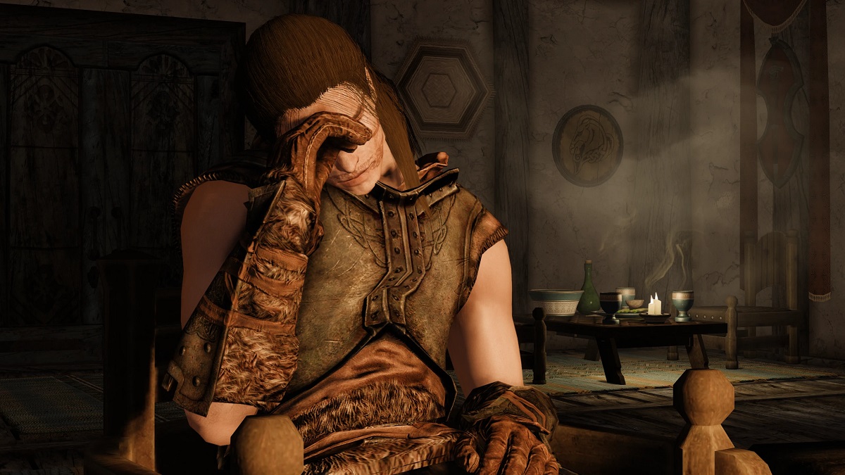 Skyrim: a character asleep on a chair with their head in their hand.