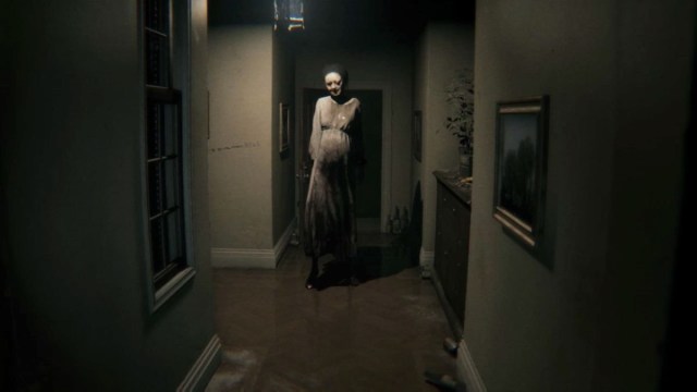 Silent Hills: a creepy looking woman down the end of a hallfway.
