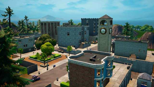 A busy town in Fortnite, with a clock tower, houses, and office buildings