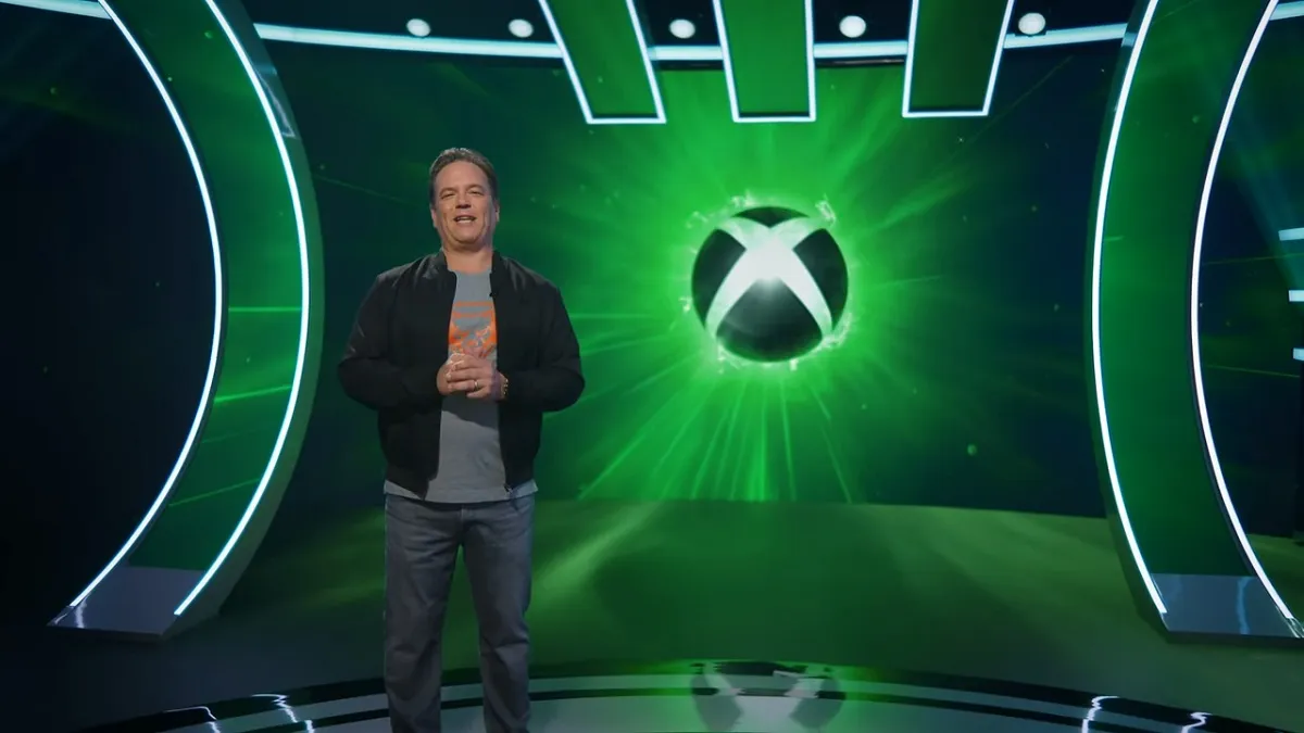 Phil Spencer standing in front of Xbox logo