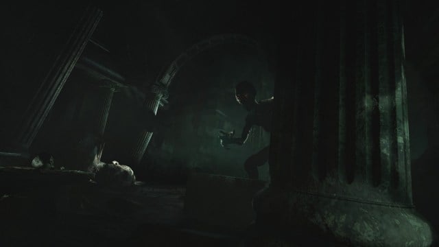 Amnesia Rebirth: a creepy, dark monster peers around from a stone column.