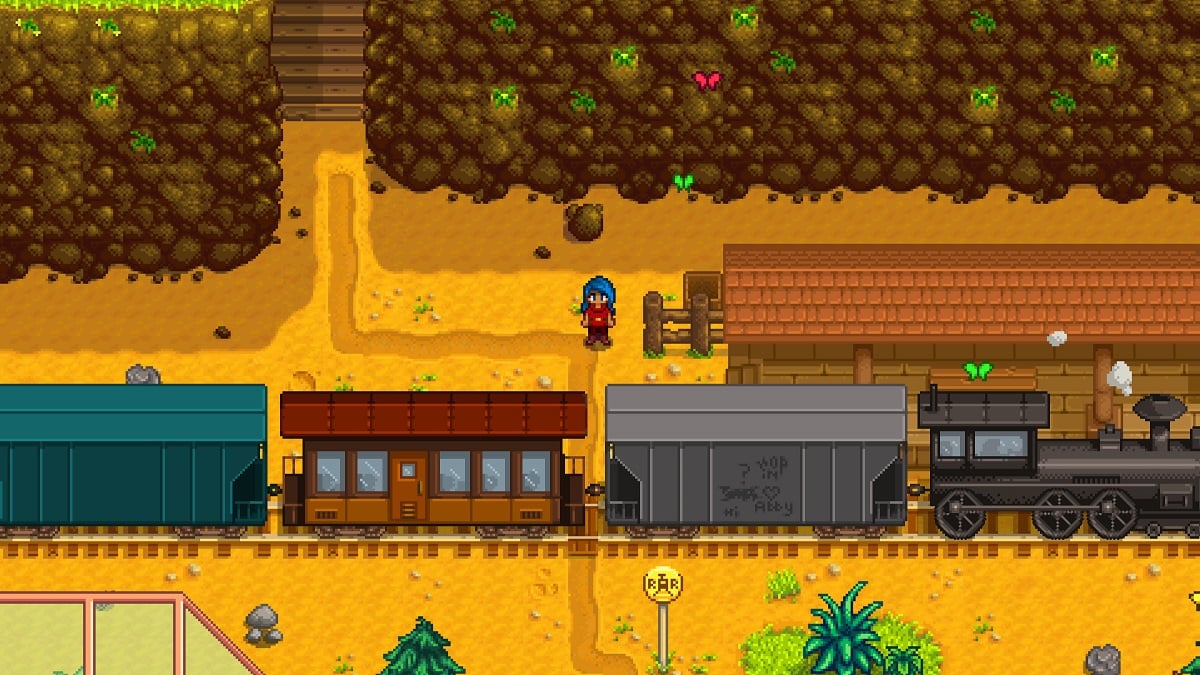 Stardew Valley: a character stand by the train station as a steam train trundles through.
