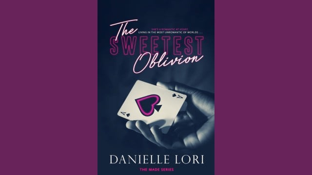 The cover of The Sweetest Oblivion, a hand holding an Ace of Clubs