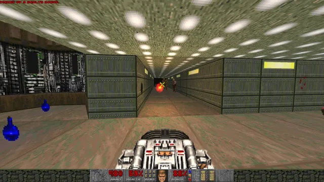 Doom: the player holds a BGF weapon as enemies attack from down a corridor.