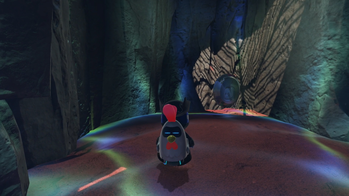 Astro Bot in a cave with light shimmering on the walls.