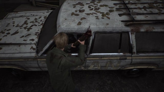 Silent Hill 2 Remake James knocking out the window of a station wagon.