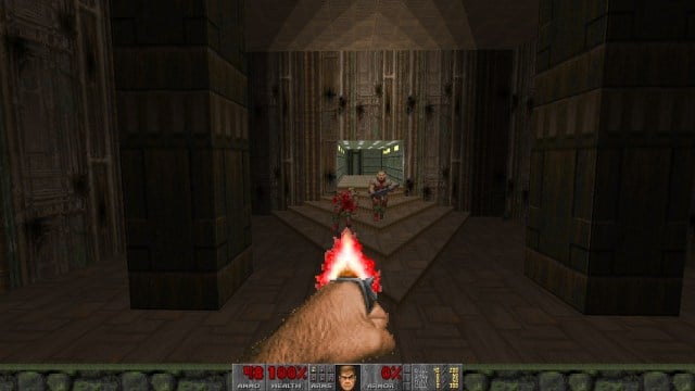  a zombie is downed by Doomguy's punching fist as though it's a pistol firing a bullet.