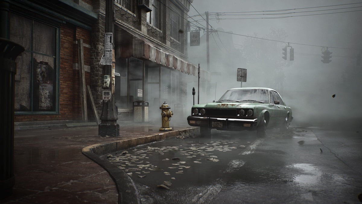 Silent Hill 2: a battered green car sits alone on a foggy street.