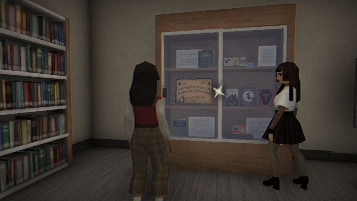 Vivian and Amy standing near the library's display case.