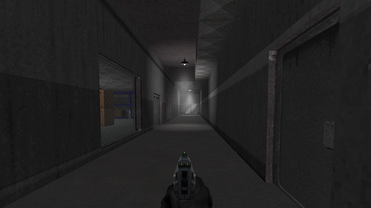 Doom 2: a hand holds a pistol down a dark, concrete corridor.